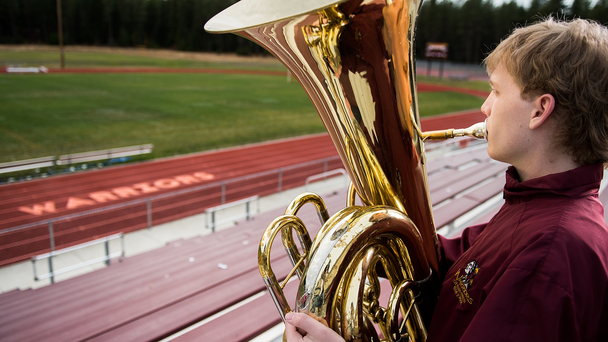 High school Senior Portraits in Roslyn boy playing his trombone