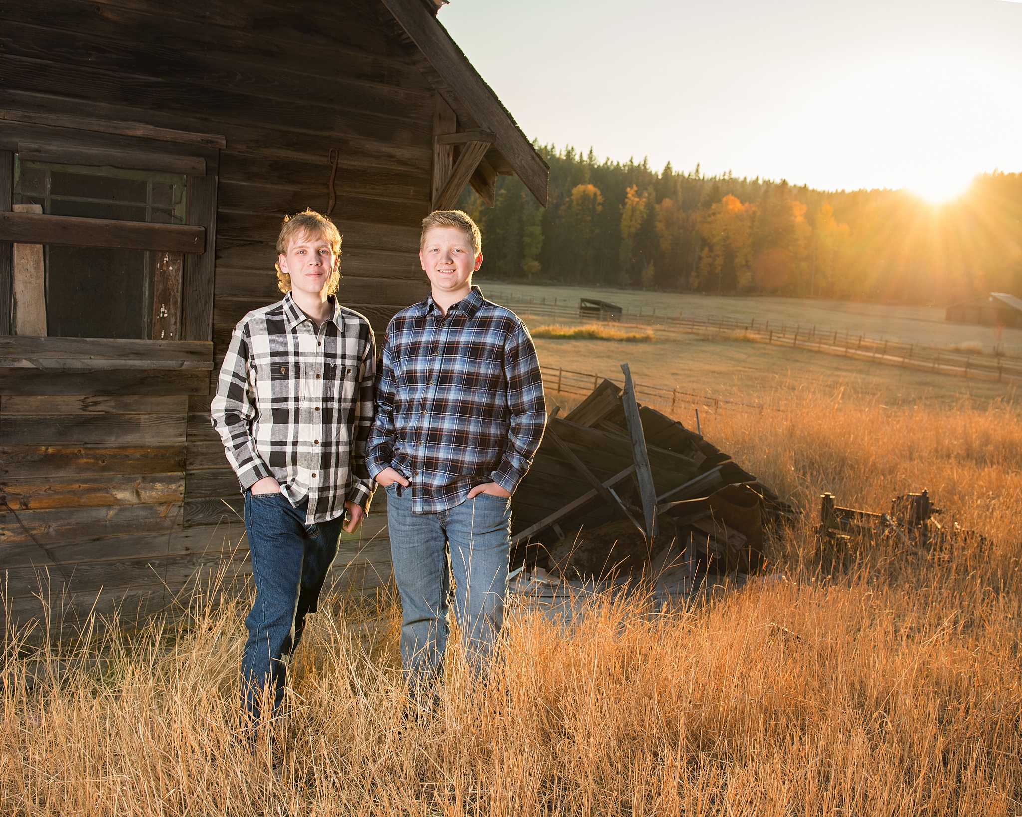 Two brothers standing in a farm field during High school Senior Portraits in Roslyn