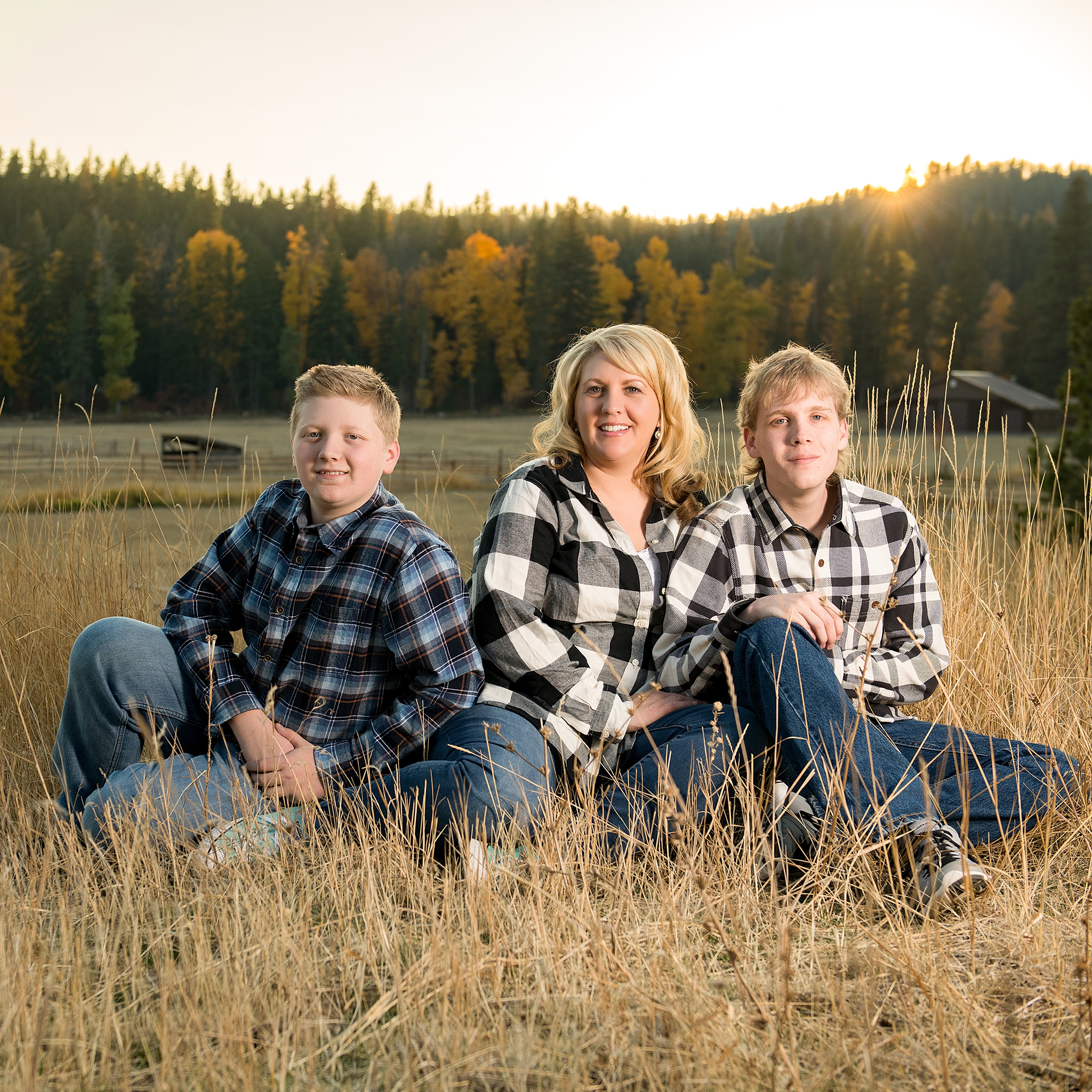 Mom with her two boys in a field during High school Senior Portraits in Roslyn