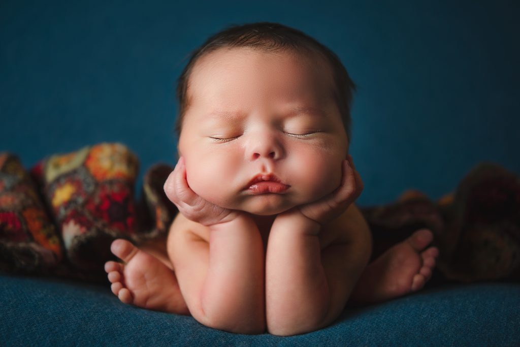 newborn baby in froggy pose. Everything You Need to Know About Newborn Photography.