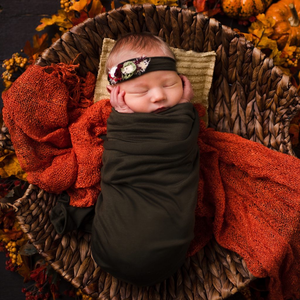 newborn baby in fall themed basket. Everything You Need to Know About Newborn Photography.