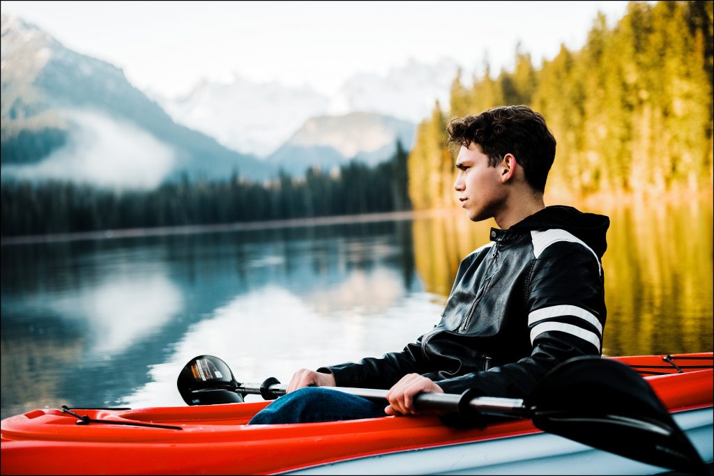 young man in kayak on lake in washington