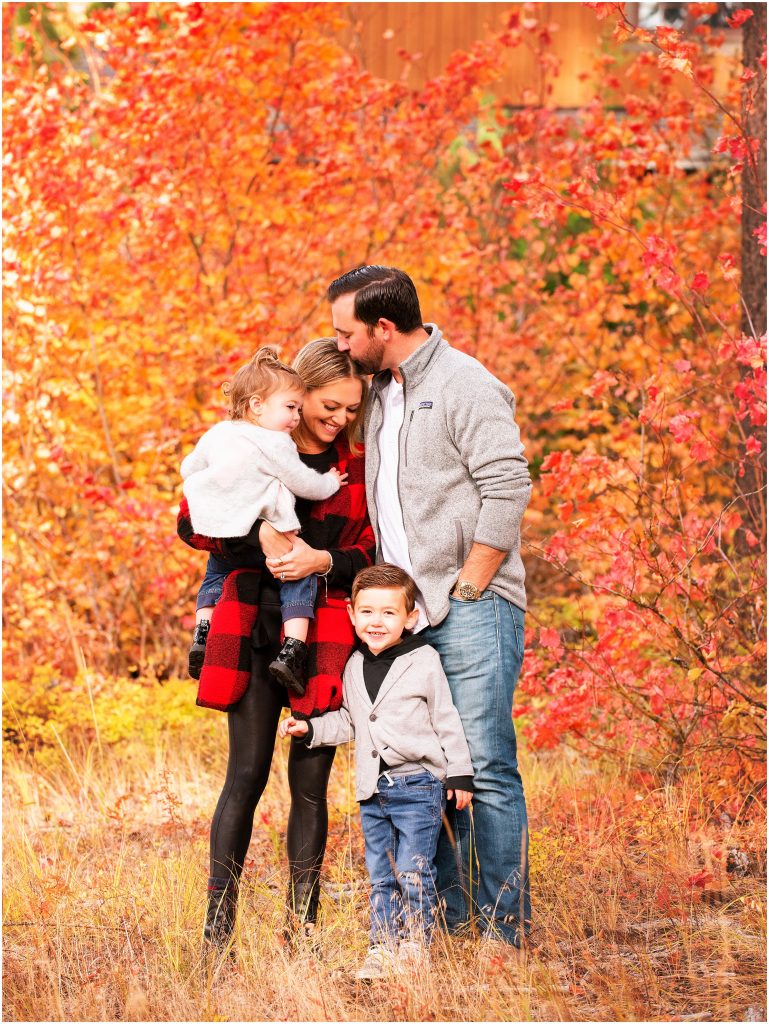 A family snuggled in the middle of fall foilage during family portraits