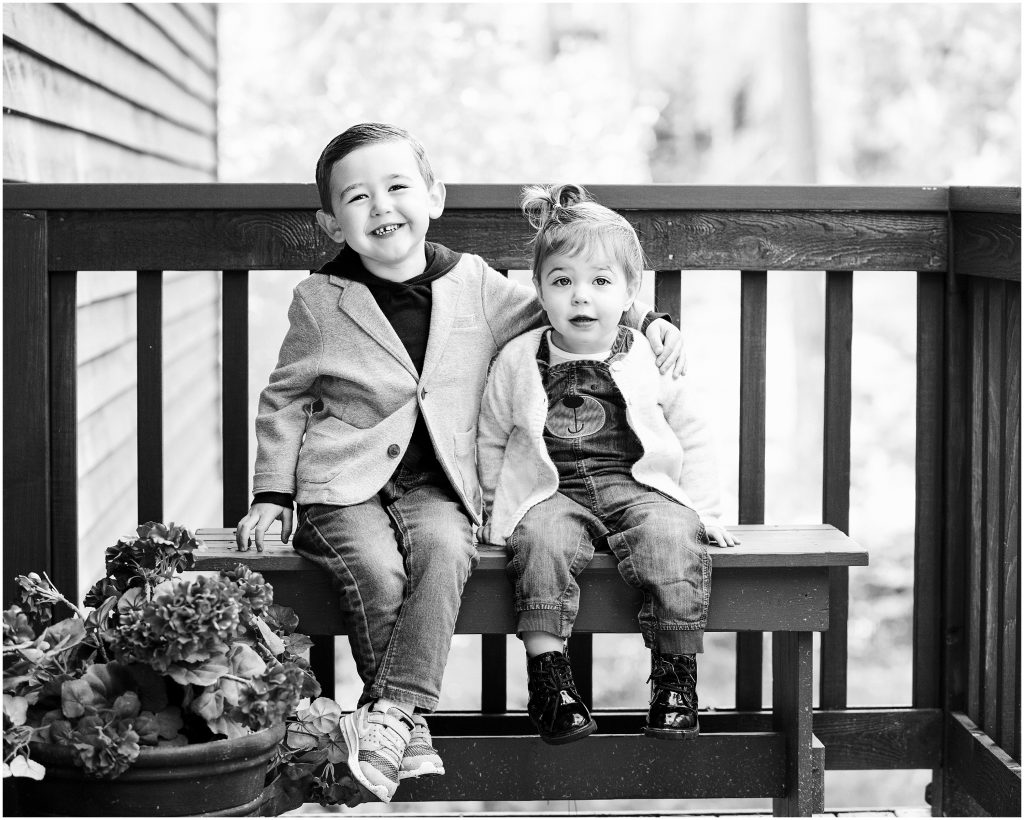 Brother holding his littler sister during portraits of toddlers during fall family photos in suncadia