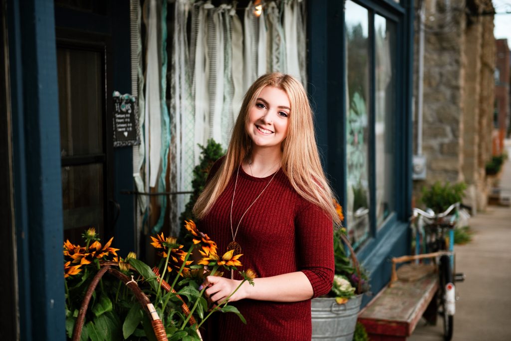 Cle Elum Senior Pictures of a girl casually standing with flowers