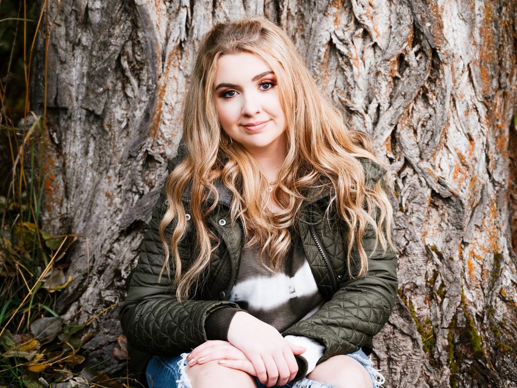 Fashionable young woman posing for her senior photos in Roslyn Washington