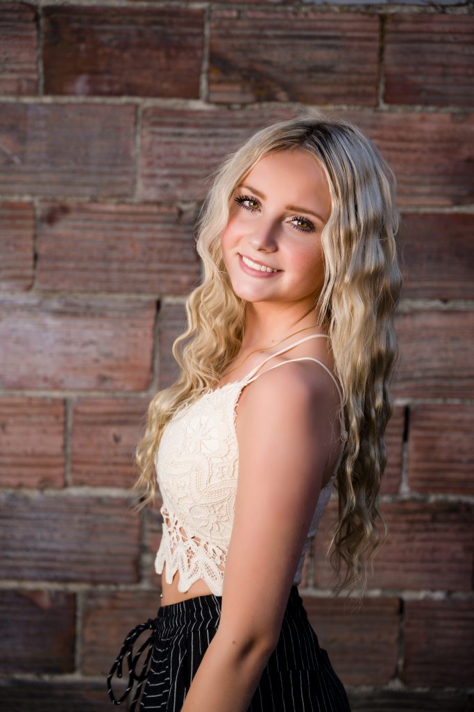 Senior Photography in Ellensburg, a young blonde girl with long hair posing in a crochet top