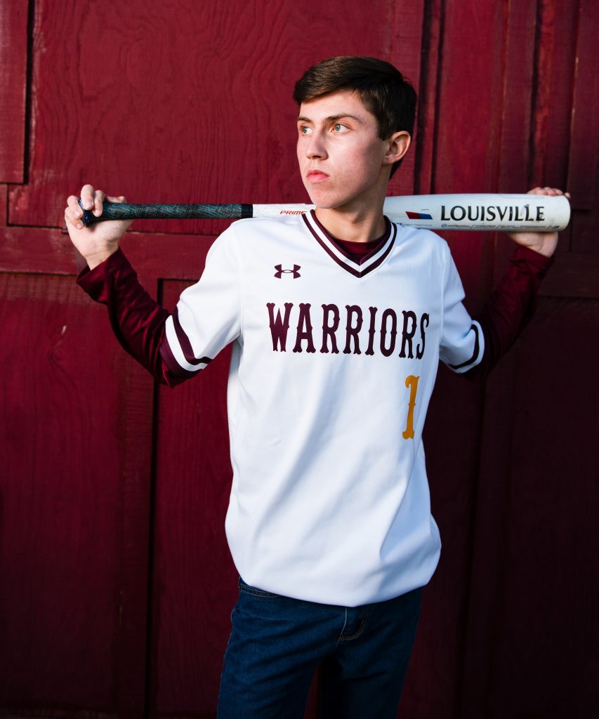 Varsity High school baseball player posing with baseball uniform cle elum roslyn highschool