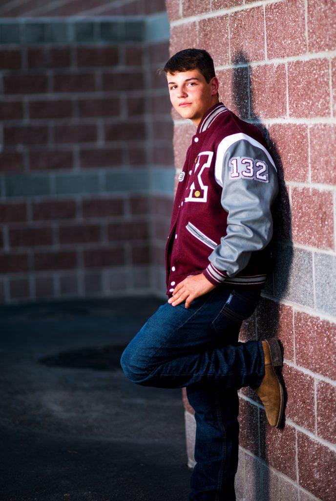 High School Senior portrait of guy wearing letterman jacket in Ellensburg WA 