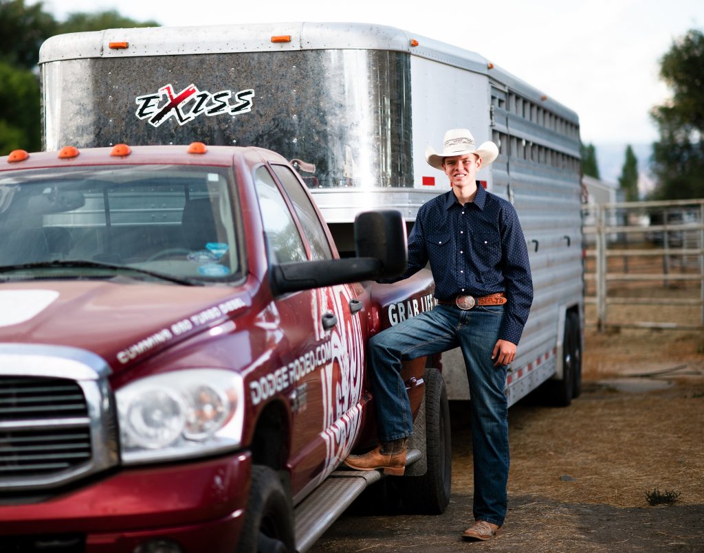 Roslyn Senior Photography senior guy standing with his rodeo livestock truck and trailer