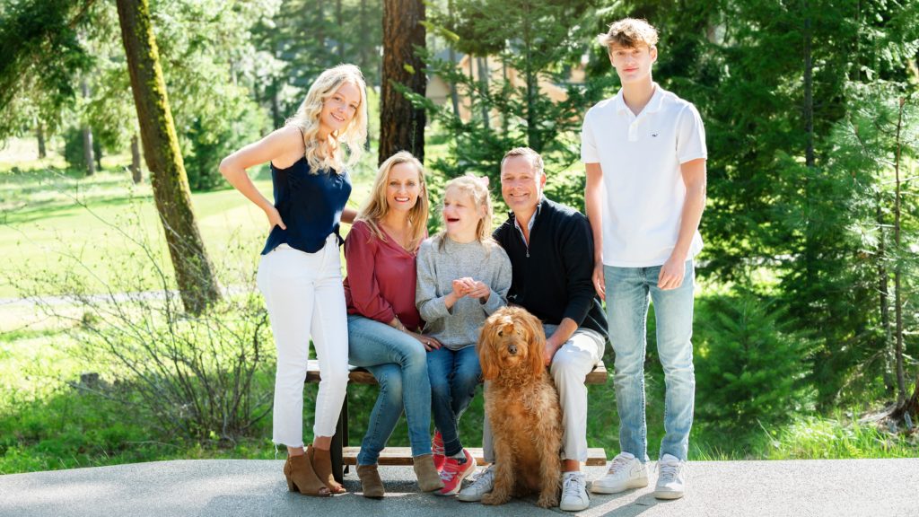 Family Photographer in Suncadia captures a family of five, two parents and three teenager children with their pet dog outdoors on a bench