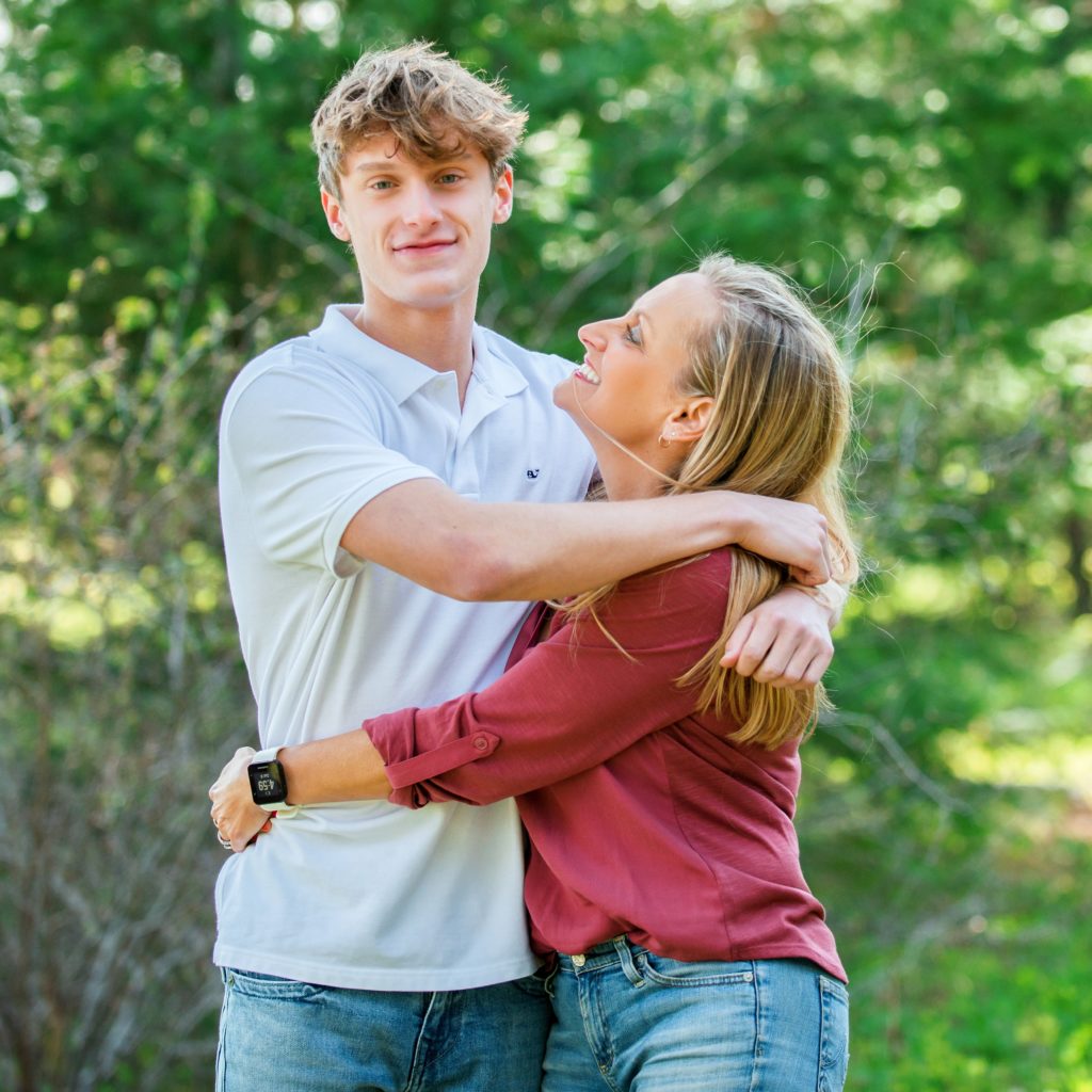 Mom hugs teenage son for family photos