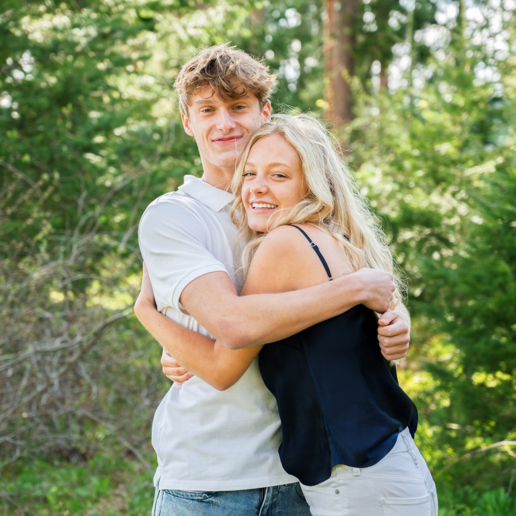 Teenage siblings, brother and sister embrace in warm hug for family portraits