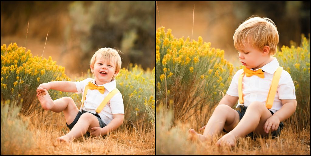 Little blonde boy in white shirt and yellow bow tie sitting in a grassy field, holding onto his bare foot. Cle Elum Photographer